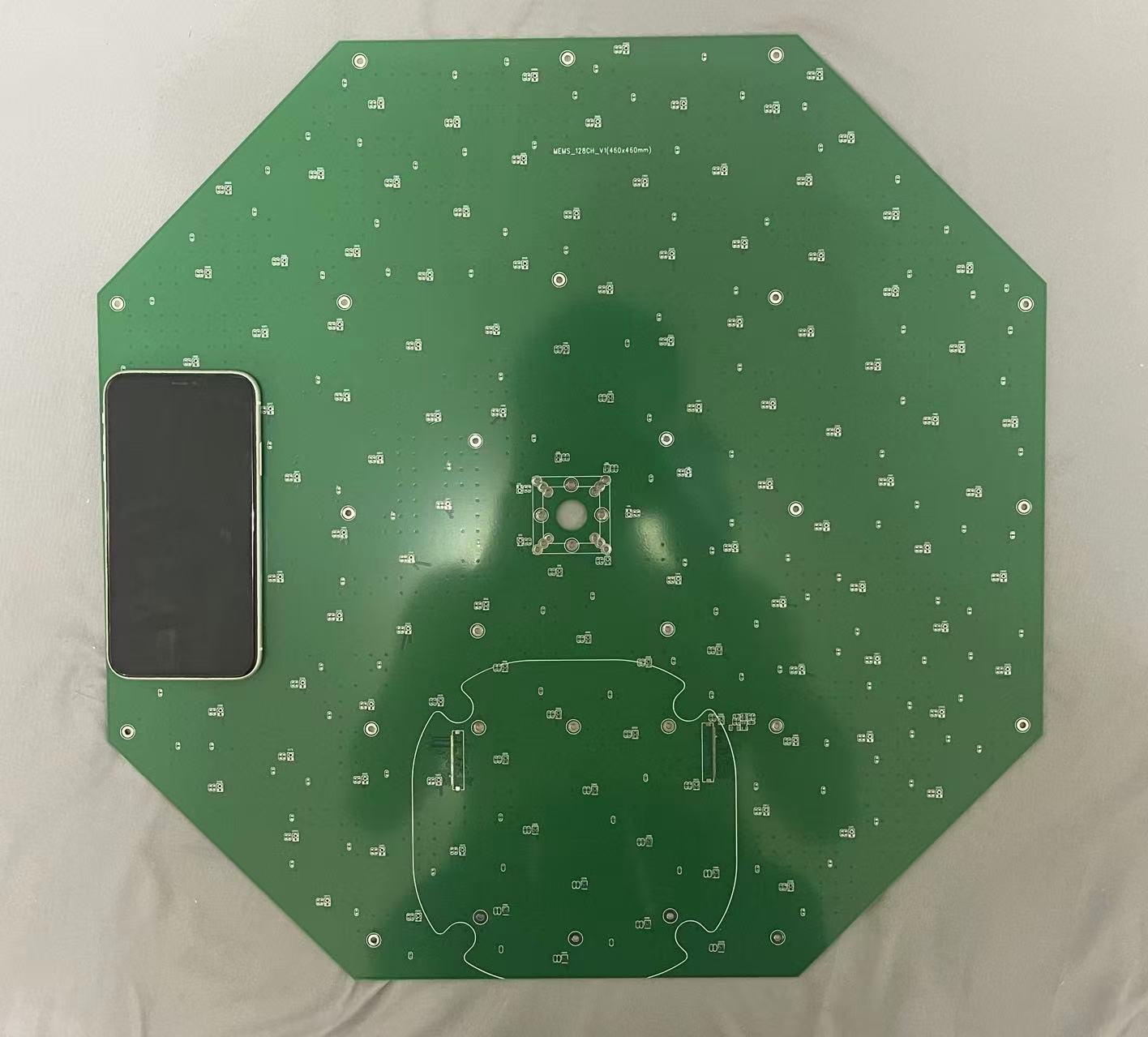 Original octagonal PCB photograph with iPhone XR for scale